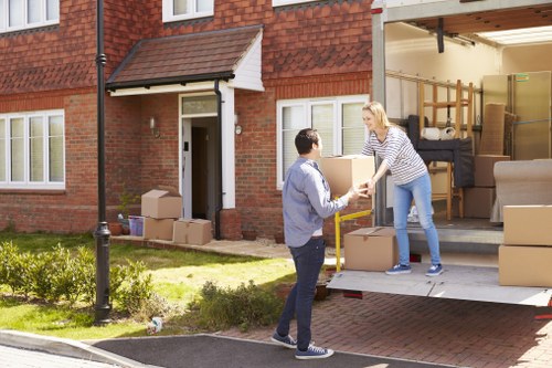 Man with van loading furniture in a Charlton residential street