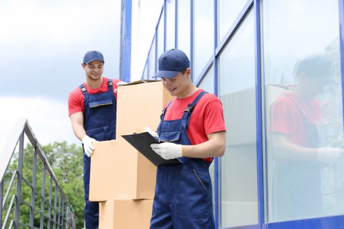 Professional flat removals in Charlton with moving team and packed boxes