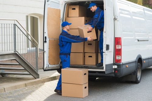 Team loading a van safely with protective equipment