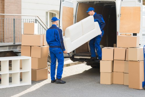 Movers wrapping and loading furniture for a Charlton home relocation