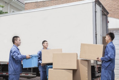Van service staff loading items safely with protective equipment