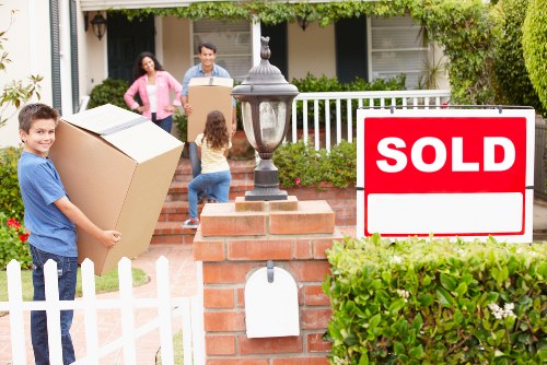 Experienced movers handling furniture carefully during a house relocation in Charlton
